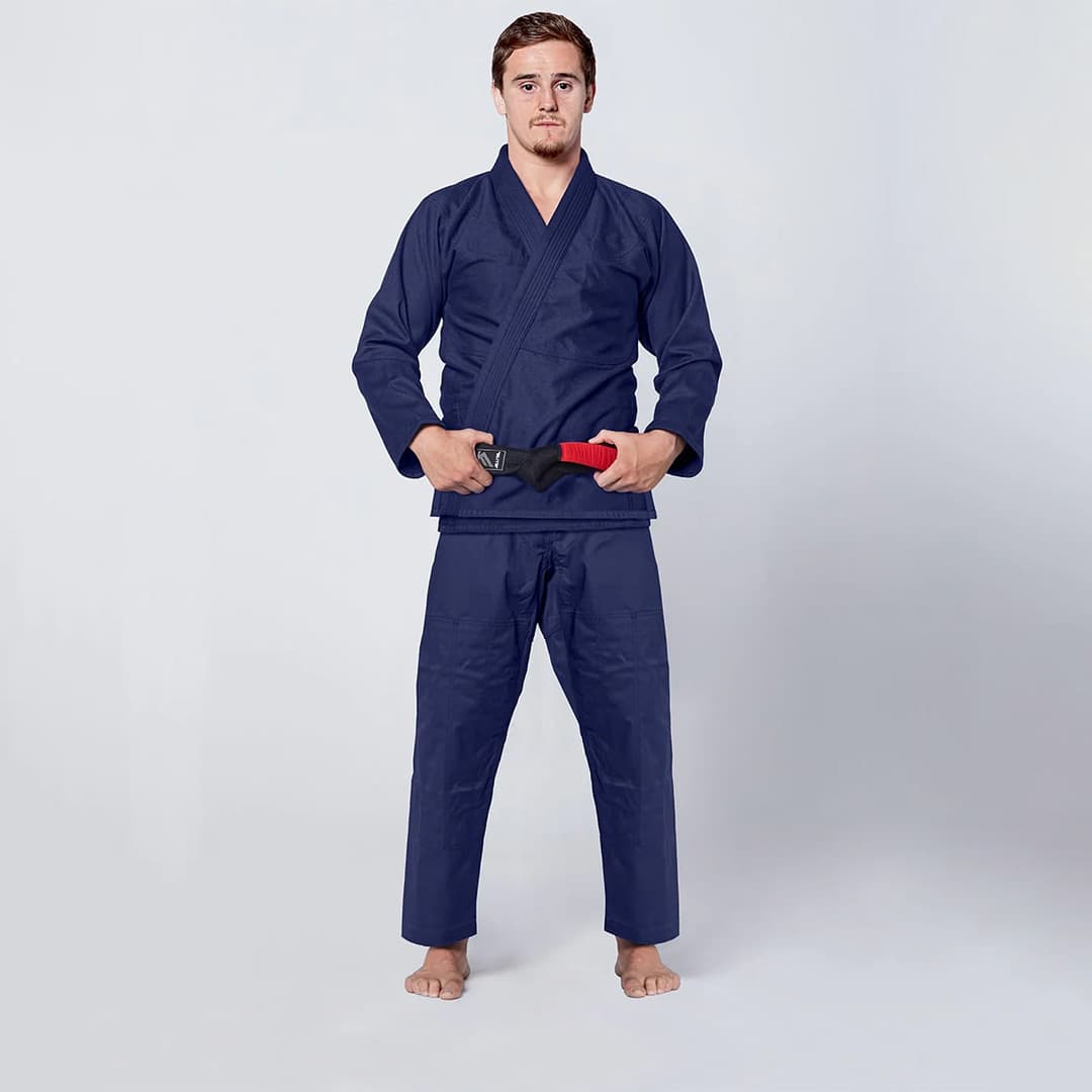 Custom judo uniform featuring a prominently embroidered team logo on the jacket and pants.