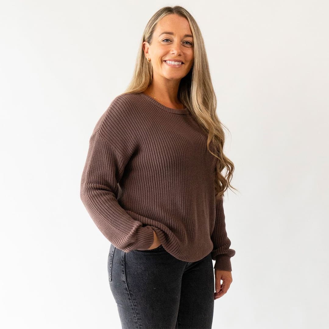 A nurse wearing a cozy custom sweater while attending to patients in a hospital environment.