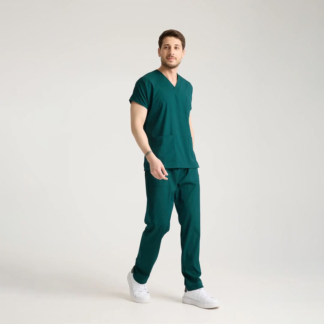 Close-up of a custom jogger scrub pant pocket embroidered with a hospital logo indicating professional medical apparel branding.