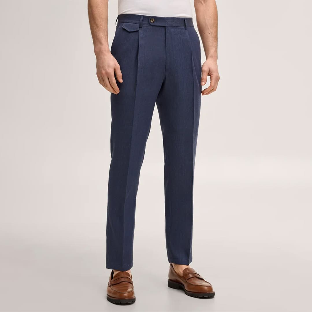 Image showing a tailor taking precise measurements for custom dress pants to ensure perfect fit and comfort for the wearer.